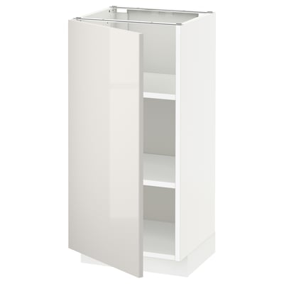 A white METOD kitchen cabinet with a glossy finish and adjustable shelves.