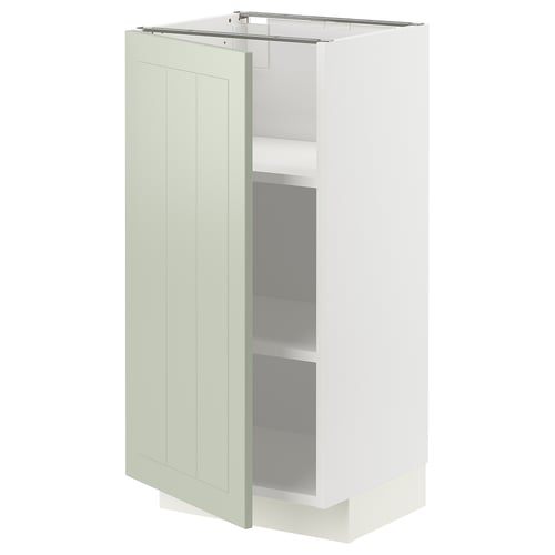 Light green kitchen cabinet, modern design, with a single door and two shelves.