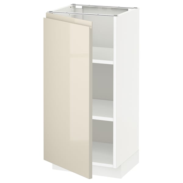 High gloss beige METOD kitchen cabinet with one open door, sleek handles, and adjustable shelves.