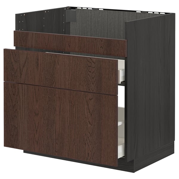 Dark brown wooden kitchen cabinet with three drawers, part of ikeas METOD system.