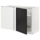 A modern white corner base cabinet with a black door from the METOD kitchen system. It has pull-out shelves for accessible storage.