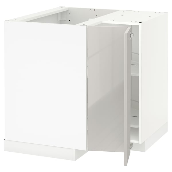 A white METOD kitchen cabinet set with high gloss finish and modern design. It a corner base cabinet with a rotating carousel for efficient storage.