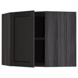 Black stained kitchen cabinet with one open door, dark wood grain.