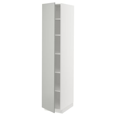 A tall white METOD cabinet with shelves, part of ikeas kitchen system, featuring a modern and sleek design.