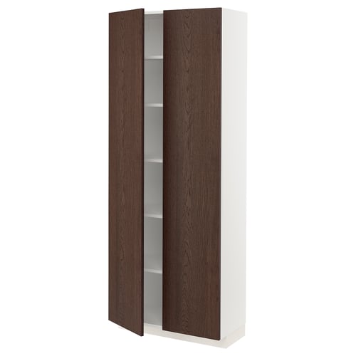 A white and dark brown ikea METOD kitchen cabinet. It wooden doors with a tall, rectangular shape. The cabinet has adjustable shelves inside.