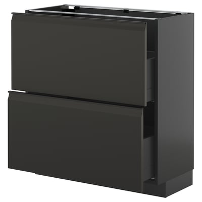 A modern black METOD kitchen cabinet with sleek handles and a high drawer.