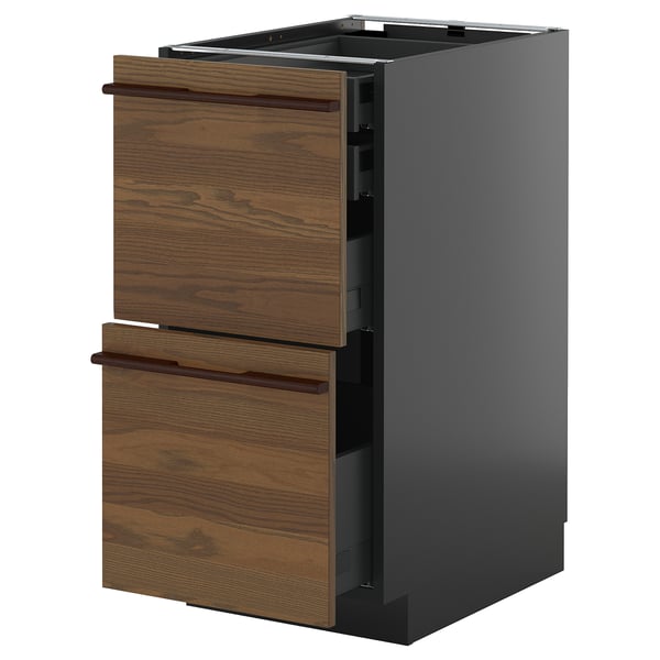 Modern kitchen cabinet with dark wood drawers and sleek handles.