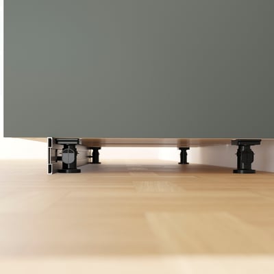 Metal kitchen cabinet legs with adjustable feet for stability on uneven floors.