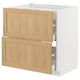Modern kitchen unit with white base, light wood drawers, and silver handles.