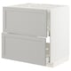 White METOD kitchen cabinet with light grey drawers and bevelled edges.
