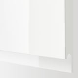 Close-up of high gloss white kitchen cabinet with smooth edges and sleek design.