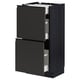 METOD kitchen unit in dark wood tone with opened black drawers.