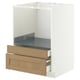 A white METOD kitchen unit with two wooden drawers, featuring oak veneer. The drawers have beveled edges and are partially pulled out.