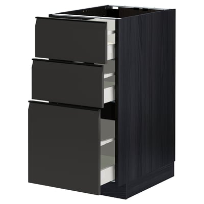 METOD kitchen unit in matte black with three open drawers, dark wood grain texture.