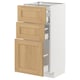 Ikea METOD white kitchen cabinet with oak drawers.