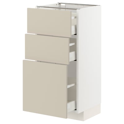 A white METOD kitchen cabinet with beige drawers, offering ample storage.