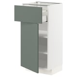 Modern kitchen unit: METOD in white with grey-green drawer. Sleek design, two adjustable shelves, and a smooth drawer.