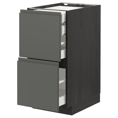 Modern kitchen unit with dark grey drawers, metallic runners, and sleek, minimalist design.