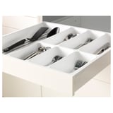 Kitchen drawer in white with multiple compartments neatly organizing cutlery and utensils.