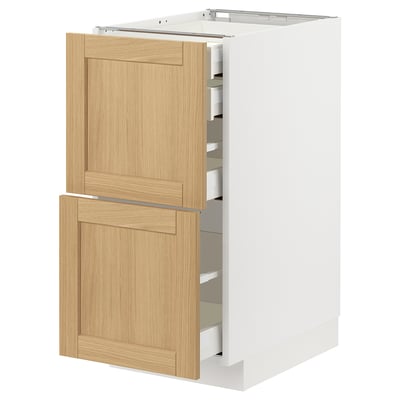 Modern kitchen cabinet: METOD with white & oak drawers, sleek design, self-closing drawers.