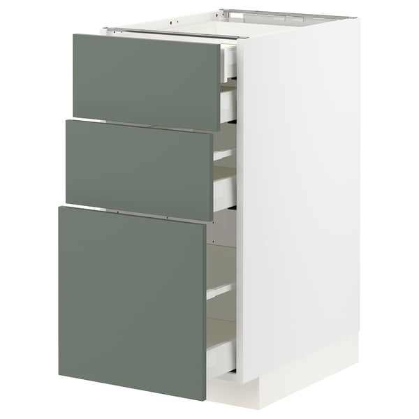 A modern white cabinet with three green-gray sliding drawers. The minimalist design fits well in contemporary kitchens.