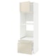 A white METOD kitchen unit with high-gloss beige drawers and cabinet doors. It shelves and a pull-out drawer.