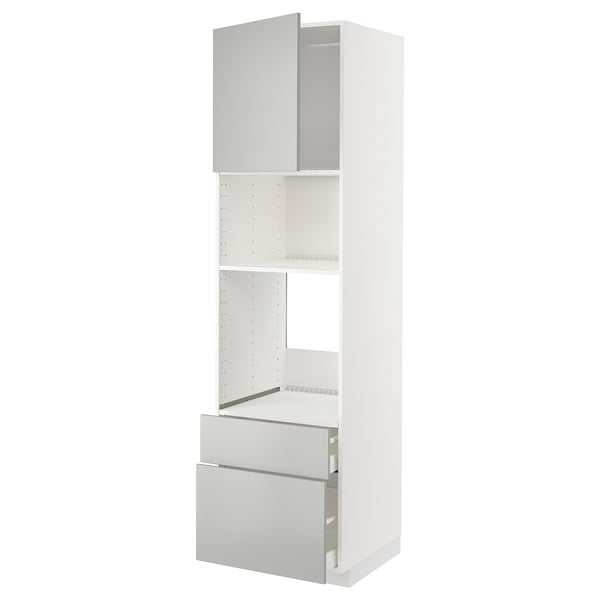 White METOD kitchen unit with light grey havstorp fronts; tall, rectangular, modern design with open shelves and drawers.