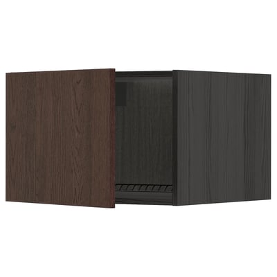 Dark brown wooden kitchen cabinet with single door open, metal hinges.