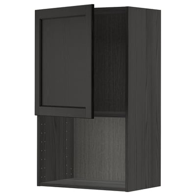 An ikea METOD wall cabinet in black stained wood with a traditional design. It has a door and adjustable shelves.