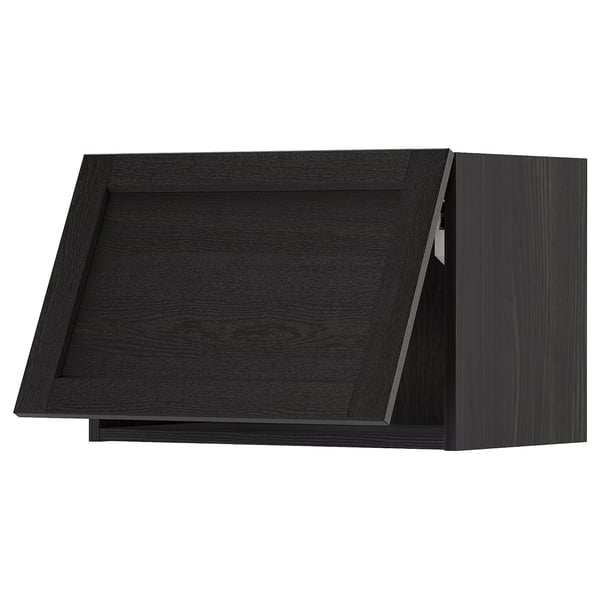 Black METOD kitchen cabinet with dark stained wooden finish and beveled edges.