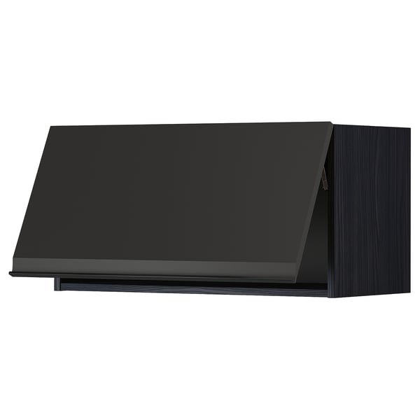 Modern black kitchen cabinet with sleek, angled edges and integrated handle.
