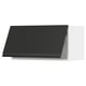 Modern black kitchen cabinet with sleek handle, angled design.