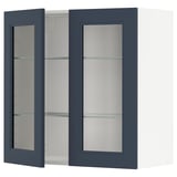 An open, dark blue wall cabinet. The cabinet has glass shelves.