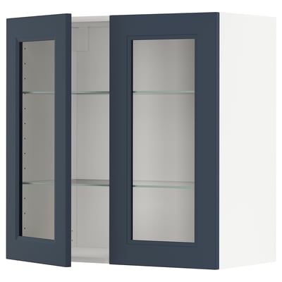 An open, dark blue wall cabinet. The cabinet has glass shelves.