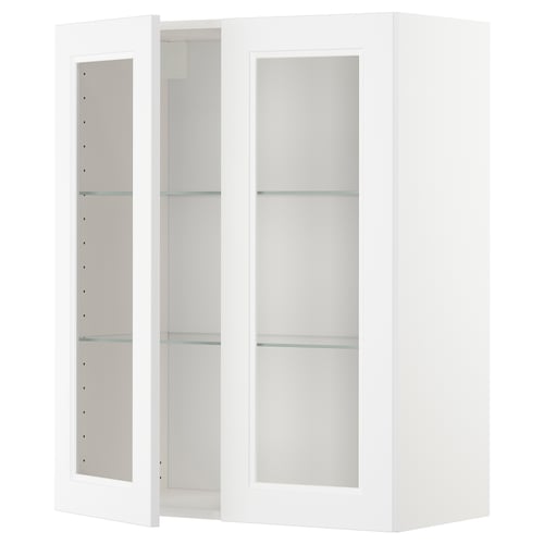 A white METOD kitchen cabinet with glass doors and adjustable shelves.