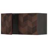 Modern dark brown kitchen unit with chevron pattern, featuring open door, part of ikeas METOD system.