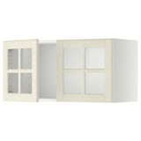 Two off-white METOD kitchen wall cabinets with glass doors and beveled edges.