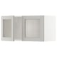 A white METOD kitchen cabinet with a light grey glass door.