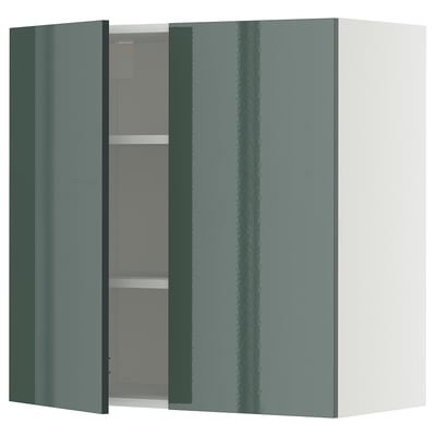Green gloss kitchen cabinet, open door showing shelves.