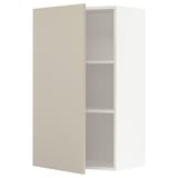 A beige METOD kitchen cabinet with a white interior and two shelves. The cabinet door is closed, and the design is sleek and modern.