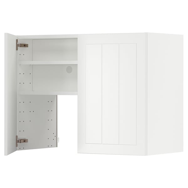 An open white METOD kitchen cabinet with adjustable shelves and hinges.