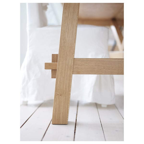 A close-up of a stylish wooden tables sturdy leg, showcasing its high-quality oak finish and natural grain pattern.