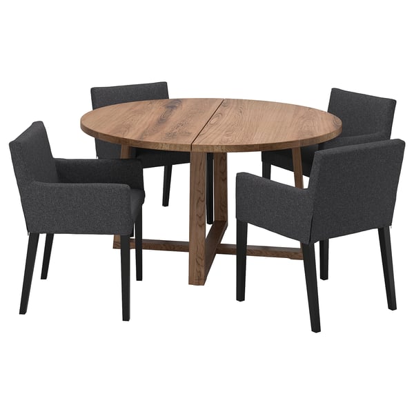 Modern round wooden dining table with four matching dark gray fabric chairs. Minimalist design, ideal for small spaces.