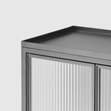 Modern cabinet with textured glass doors and sleek metal edges. Ideal for stylish storage.