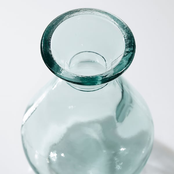 Clear glass vase with bubbly texture and smooth edges, reflecting light.