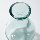 Clear glass vase with bubbly texture and smooth edges, reflecting light.