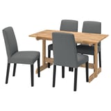 Square wooden dining table with four grey fabric chairs. Simple, modern design.
