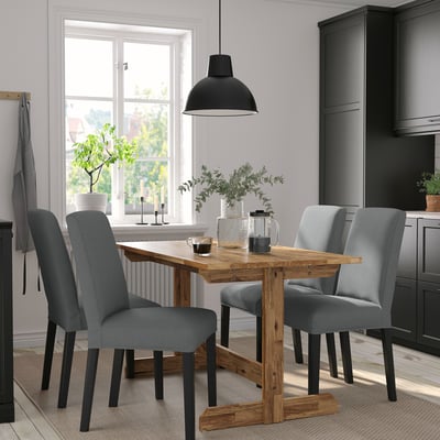 NACKANÄS dining set with acacia wood table & grey chairs, seating 4-6, near a window with pendant light and rug.