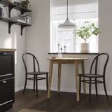 Cozy dining setup with NACKANÄS table & chairs in minimalist kitchen, featuring solid acacia and beech, greenery, and functional decor.