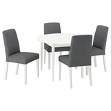 A NÄSINGE dining set with a white round table and four gray fabric chairs. Modern, clean design with wooden legs.